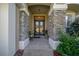 Covered front entryway with stone pillars, double doors, and a tiled patio, providing a welcoming entrance at 811 Se 49Th Ave, Ocala, FL 34471