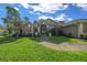 Charming single-story home with a lush green lawn, beautiful landscaping, and a welcoming walkway to the front door at 811 Se 49Th Ave, Ocala, FL 34471