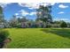 Spacious front yard of a single-story home with well-maintained lawn, mature trees, and pleasant curb appeal at 811 Se 49Th Ave, Ocala, FL 34471