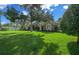 Attractive single-story home with a well-manicured front lawn, mature trees, and neatly trimmed bushes at 811 Se 49Th Ave, Ocala, FL 34471