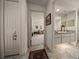 Hallway view into sitting area and bathroom with neutral paint and tile flooring at 811 Se 49Th Ave, Ocala, FL 34471