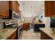 Open kitchen with stainless steel appliances, granite countertops and custom cabinets at 811 Se 49Th Ave, Ocala, FL 34471