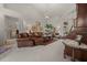 This bright living room features plush seating, a crystal chandelier, and neutral carpeting at 811 Se 49Th Ave, Ocala, FL 34471