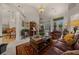 An open-concept living area features a chandelier, leather sofas, and easy access to dining and bar seating at 811 Se 49Th Ave, Ocala, FL 34471