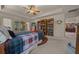 Spacious main bedroom boasts a decorative ceiling, a ceiling fan, and sliding doors to the lanai at 811 Se 49Th Ave, Ocala, FL 34471