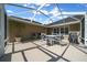 Enclosed patio offering an ideal setting for entertainment, with a table, chairs, and a clear view of the sky at 811 Se 49Th Ave, Ocala, FL 34471