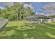 Spacious backyard featuring lush green grass and privacy fence ideal for outdoor enjoyment at 838 Nw 124Th Street, Citra, FL 32113
