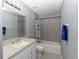 Bathroom with shower-tub combo, white vanity, and updated fixtures at 838 Nw 124Th Street, Citra, FL 32113