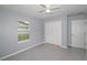 Bright bedroom featuring a ceiling fan, large window, tile floors, and a double-door closet at 838 Nw 124Th Street, Citra, FL 32113