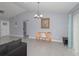 Bright dining area featuring gray tile flooring, a modern chandelier and neutral colored walls at 838 Nw 124Th Street, Citra, FL 32113