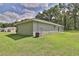 Side view of the home with an air conditioning unit on a well-maintained lawn at 838 Nw 124Th Street, Citra, FL 32113