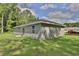 Exterior view of home showing backyard patio and lush green lawn at 838 Nw 124Th Street, Citra, FL 32113