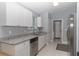 Well-lit kitchen with stainless steel appliances, white cabinets, and granite countertops at 838 Nw 124Th Street, Citra, FL 32113