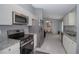 Modern kitchen featuring stainless steel appliances, granite countertops, and white cabinets at 838 Nw 124Th Street, Citra, FL 32113