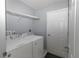 Functional laundry room with a washer, dryer, and shelving at 838 Nw 124Th Street, Citra, FL 32113