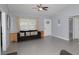 Comfortable living room features gray tile flooring, neutral walls, and abundant natural light at 838 Nw 124Th Street, Citra, FL 32113