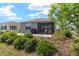 Well landscaped backyard with a brick paver patio, outdoor grill, and screened-in porch at 8693 Sw 76Th Ln, Ocala, FL 34481
