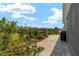 Beautiful backyard featuring a brick paver patio, green landscaping, and clear blue skies at 8693 Sw 76Th Ln, Ocala, FL 34481