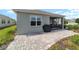 Paver patio, green landscaping, and grill included in this private backyard space at 8693 Sw 76Th Ln, Ocala, FL 34481