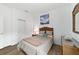 Cozy bedroom with wicker furniture, comfortable bed, and wood-look flooring at 8693 Sw 76Th Ln, Ocala, FL 34481