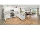 Open-concept kitchen with a granite island, white cabinets, and stainless steel appliances at 8693 Sw 76Th Ln, Ocala, FL 34481