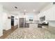Bright kitchen featuring white cabinets, stainless steel appliances, and granite countertops at 8693 Sw 76Th Ln, Ocala, FL 34481