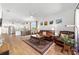 Spacious living room with a ceiling fan that flows into the kitchen and dining area at 8693 Sw 76Th Ln, Ocala, FL 34481