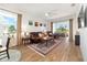 The living room has a ceiling fan, backyard views, comfortable seating, and a warm rug at 8693 Sw 76Th Ln, Ocala, FL 34481