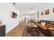 The open-concept living space features a modern kitchen, backyard views, and comfortable seating at 8693 Sw 76Th Ln, Ocala, FL 34481