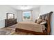 The main bedroom features ample natural light, a ceiling fan, and neutral decor for a serene retreat at 8693 Sw 76Th Ln, Ocala, FL 34481