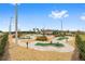 Community mini golf course featuring multiple greens, paver paths, park benches and professional landscaping at 8693 Sw 76Th Ln, Ocala, FL 34481