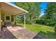 Back patio with brick pavers, an awning, and a view of the lush green lawn at 8747 Sw 98Th Street Rd # F, Ocala, FL 34481