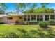 Expansive backyard with well-maintained lawn, mature landscaping, and a covered patio at 8747 Sw 98Th Street Rd # F, Ocala, FL 34481