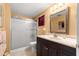 The bathroom has a shower, a sink with a large mirror and peach colored walls at 8747 Sw 98Th Street Rd # F, Ocala, FL 34481