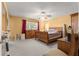 This bedroom includes a ceiling fan, a comfortable bed and lots of natural light from the window at 8747 Sw 98Th Street Rd # F, Ocala, FL 34481
