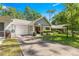 This home has a manicured lawn, cozy front porch, and attached garage, all under a sunny blue sky at 8747 Sw 98Th Street Rd # F, Ocala, FL 34481