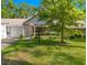 Charming single-story home with a well-manicured lawn, mature tree, and attached garage at 8747 Sw 98Th Street Rd # F, Ocala, FL 34481