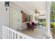 Comfortable front porch featuring seating and a ceiling fan, providing a welcoming entry at 8747 Sw 98Th Street Rd # F, Ocala, FL 34481