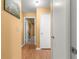 This hallway has wood floors, and a closet and it connects to other rooms at 8747 Sw 98Th Street Rd # F, Ocala, FL 34481