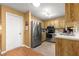This kitchen is well lit and features wooden cabinets and stainless steel appliances at 8747 Sw 98Th Street Rd # F, Ocala, FL 34481
