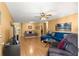 Inviting living room features hardwood floors, ceiling fan, and comfortable seating arrangement at 8747 Sw 98Th Street Rd # F, Ocala, FL 34481