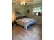 Cozy bedroom featuring neutral tones, wood-look flooring, and a window unit for comfortable living at 8951 Sw 202Nd Avenue Rd, Dunnellon, FL 34431