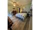 Comfortable bedroom featuring wood floors, ceiling fan, and natural light, creating a serene retreat at 8951 Sw 202Nd Avenue Rd, Dunnellon, FL 34431