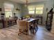 Well-lit dining room with wood floors and a wooden table perfect for meals and entertaining at 8951 Sw 202Nd Avenue Rd, Dunnellon, FL 34431