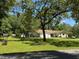Spacious home with a large yard, mature trees, and a convenient two-car garage at 8951 Sw 202Nd Avenue Rd, Dunnellon, FL 34431