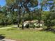 Charming single-story home with a well-manicured front yard, mature trees and a driveway at 8951 Sw 202Nd Avenue Rd, Dunnellon, FL 34431