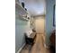 Hallway with a stylish bench, floating shelves, and wood-look flooring, creating an inviting entrance at 8951 Sw 202Nd Avenue Rd, Dunnellon, FL 34431