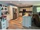 Spacious kitchen with stainless steel refrigerator, white cabinets and an island offering extra prep space at 8951 Sw 202Nd Avenue Rd, Dunnellon, FL 34431