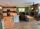 An open floor plan integrates the kitchen and living room, showcasing the stone fireplace at 8951 Sw 202Nd Avenue Rd, Dunnellon, FL 34431