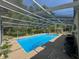 Wide view of a sparkling in-ground screened pool offering a serene outdoor retreat at 8951 Sw 202Nd Avenue Rd, Dunnellon, FL 34431